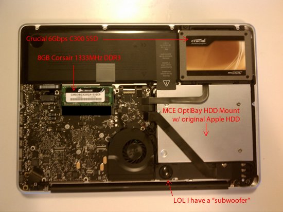 MacBook Pro internals with upgrades labeled: Crucial C300 6Gbps SSD, 8GB 1333MHz DDR3 RAM, MCE OptiBay Hard Drive bay