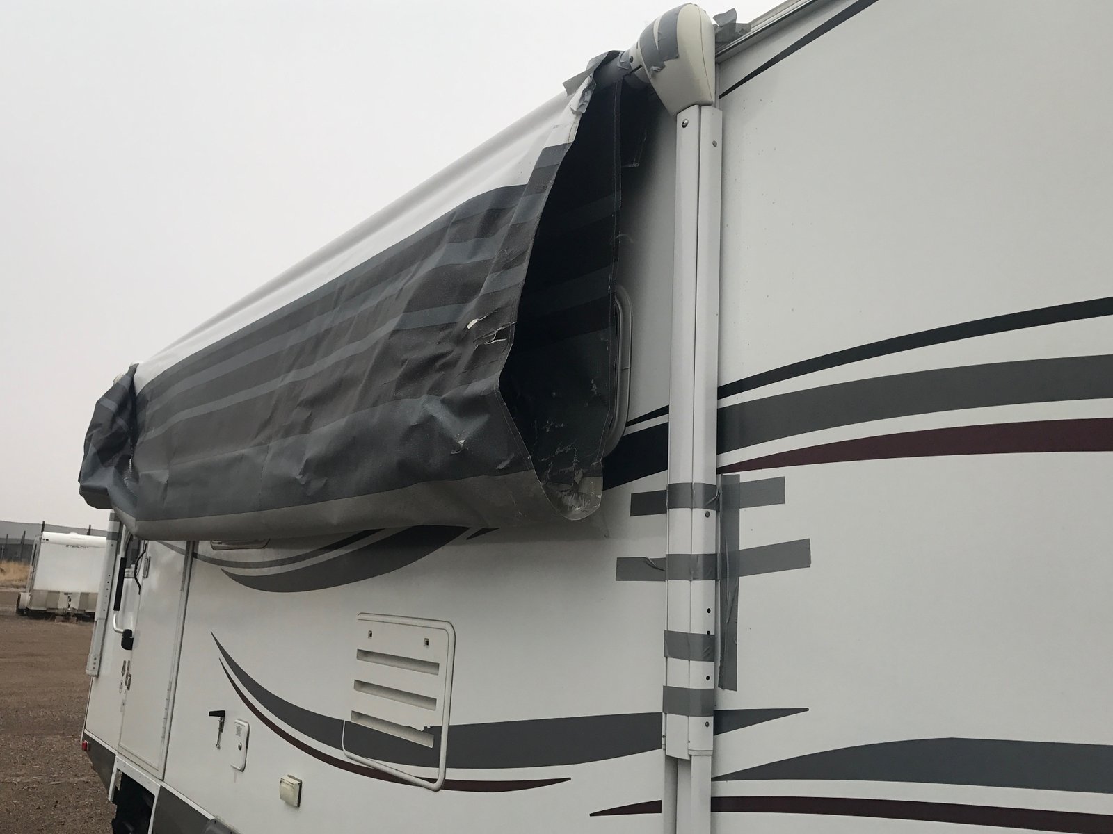 The awning over my trailer, fully unfurled and being ripped up by the elements.